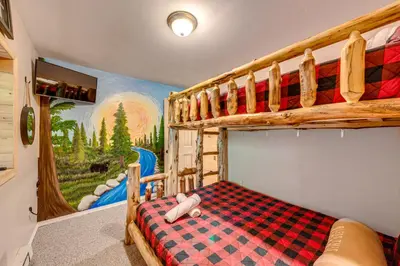 a bedroom with a checkered bed in a cabin at Game Room, Hot Tub! Cabin 9 Mi to Big Boulder Mtn in Albrightsville