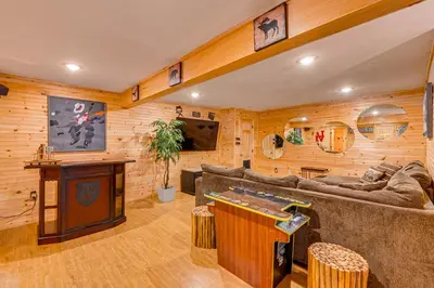 a living room with wooden walls and a pool table at Game Room, Hot Tub! Cabin 9 Mi to Big Boulder Mtn in Albrightsville
