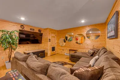 a living room with a couch and a flat screen tv at Game Room, Hot Tub! Cabin 9 Mi to Big Boulder Mtn in Albrightsville