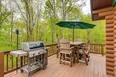a grill and a table on a deck with a grill at Game Room, Hot Tub! Cabin 9 Mi to Big Boulder Mtn in Albrightsville