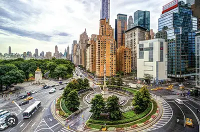 a city street with traffic in a city with tall buildings at Private Room with Shared Bathroom at an Apartment by Times Square in New York