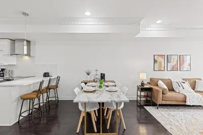 a kitchen and living room with a table and chairs at Elegant Urban Retreat in the Heart of Center City in Philadelphia