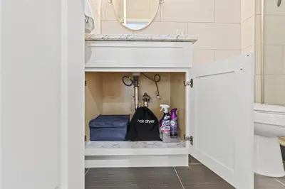 a bathroom with a closet with a sink and a mirror at Elegant Urban Retreat in the Heart of Center City in Philadelphia