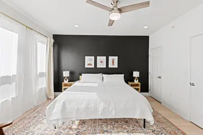 a bedroom with a bed and a black wall at Elegant Urban Retreat in the Heart of Center City in Philadelphia
