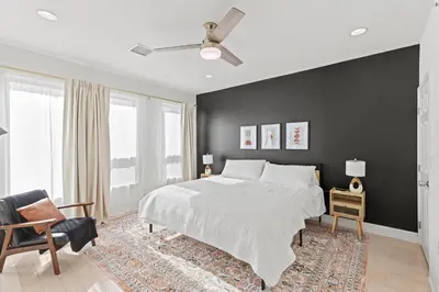 a bedroom with a bed and a black wall at Elegant Urban Retreat in the Heart of Center City in Philadelphia