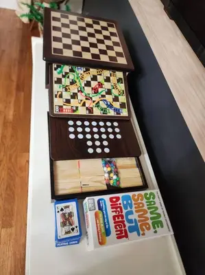 a table with a chess board and magazines on it at Chic Spacious Apt Near Attractions/Food/EWR/NYC in West Orange