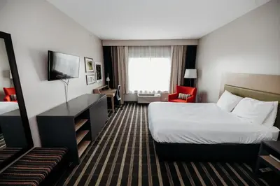 a hotel room with a bed and a television at Parkview Inn & Suites, Lancaster Amish Country, PA in Lancaster