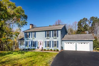 a large white house with a garage at Catskills Delaware River Modern Colonial Getaway in Narrowsburg
