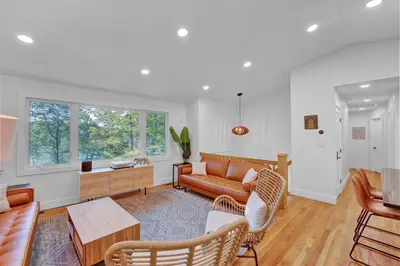 a living room with a couch and a table at Lakeside, Dock, Hot Tub, Kayaks, Arcade, Playset in Lake Ariel
