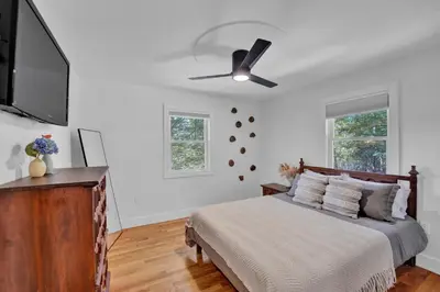a bedroom with a bed and a ceiling fan at Lakeside, Dock, Hot Tub, Kayaks, Arcade, Playset in Lake Ariel