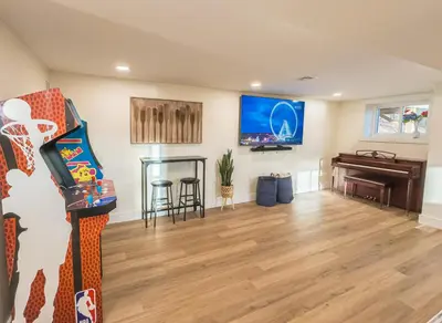a living room with a piano and a television at Lakeside, Dock, Hot Tub, Kayaks, Arcade, Playset in Lake Ariel