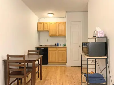 a small kitchen with a table and a microwave at Shered bathroom 4 SofaBed + loftbed + kitchen in New York