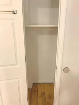 an empty closet with a white door and a wooden floor at Shered bathroom 4 SofaBed + loftbed + kitchen in New York