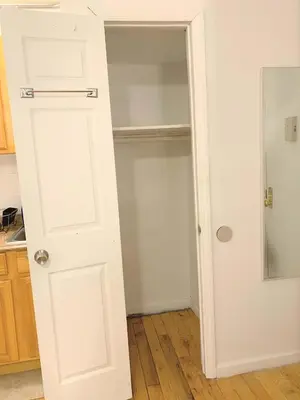 a closet with a white door in a kitchen at Shered bathroom 4 SofaBed + loftbed + kitchen in New York