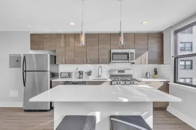 a kitchen with a refrigerator and a table with chairs at Avenue B946 City Urban Retreat, 2Br, Free Parking in Philadelphia