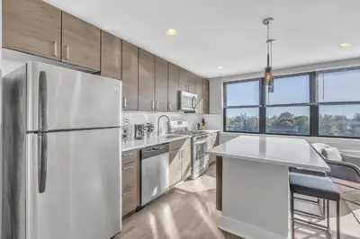 a kitchen with stainless steel appliances and a white refrigerator at Avenue B946 City Urban Retreat, 2Br, Free Parking in Philadelphia