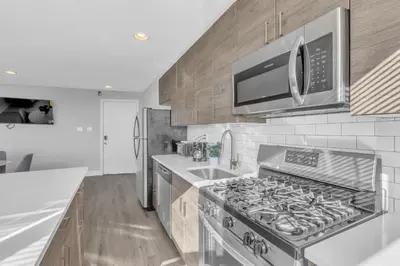 a kitchen with a stainless steel stove and a microwave at Avenue B946 City Urban Retreat, 2Br, Free Parking in Philadelphia