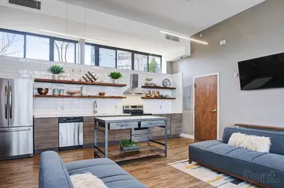 a living room with a couch and a kitchen at Avenue B946 City Urban Retreat, 2Br, Free Parking in Philadelphia