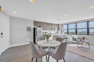 a white kitchen with a table and chairs at Avenue B946 City Urban Retreat, 2Br, Free Parking in Philadelphia