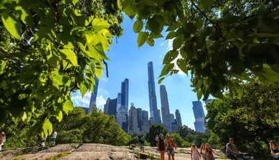 people standing in a park with a city in the background at Oasis Room at a Shared Apartment by Times Square in New York
