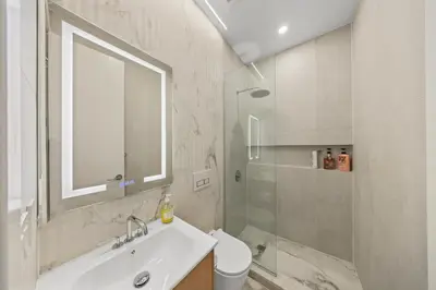 a white bathroom with a sink and a shower at Oasis Room at a Shared Apartment by Times Square in New York