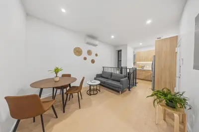 a living room with a couch and a table at Oasis Room at a Shared Apartment by Times Square in New York