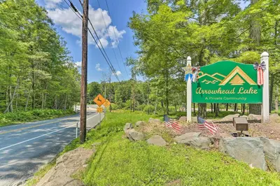 a sign for aucuildford bridge with two american flags at Arrowhead Lake Retreat with Private Indoor Pool! in Pocono Lake