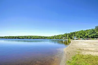 a view of a lake with trees in the background at Arrowhead Lake Retreat with Private Indoor Pool! in Pocono Lake