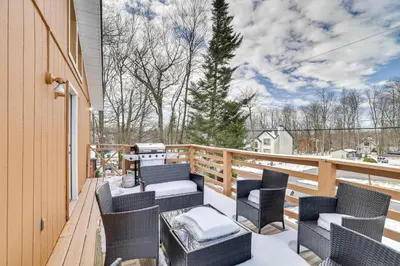 a balcony with wicker chairs and a table at Game Room and Pool Access Pocono Paradise Haven in Tobyhanna