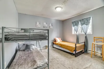 a bedroom with two bunk beds and a chair at Game Room and Pool Access Pocono Paradise Haven in Tobyhanna