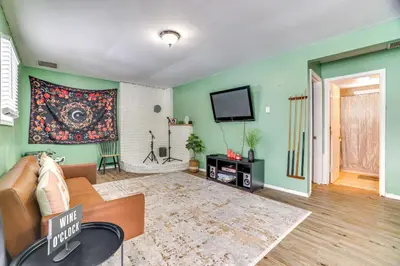 a living room with a couch and a flat screen tv at Game Room and Pool Access Pocono Paradise Haven in Tobyhanna