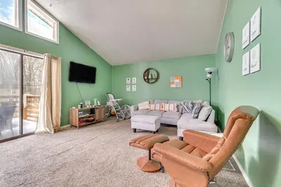 a living room with green walls and a couch at Game Room and Pool Access Pocono Paradise Haven in Tobyhanna