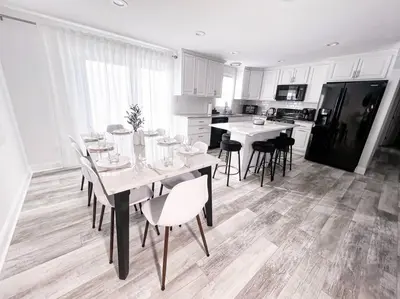 a dining room with a table and chairs and a kitchen at Cozy Getaway Lodge & Retreat in Mechanicsburg