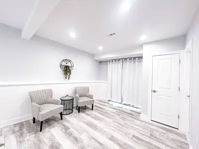 a living room with two chairs and a table at Cozy Getaway Lodge & Retreat in Mechanicsburg
