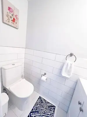 a white bathroom with a toilet and a sink at Cozy Getaway Lodge & Retreat in Mechanicsburg