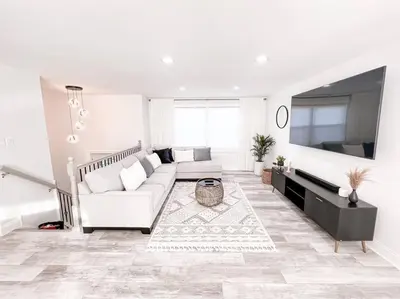 a white living room with a couch and a tv at Cozy Getaway Lodge & Retreat in Mechanicsburg