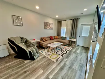 a living room with a couch and a table at The Stylish Suite - 1BR with Free Parking in Paterson