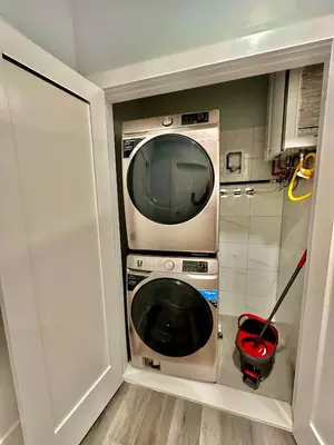 a washer and dryer in a small kitchen at The Stylish Suite - 1BR with Free Parking in Paterson