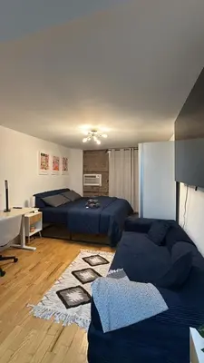 a bedroom with two beds and a desk in it at Oasis Retreat - Cozy studio in Union Square in New York