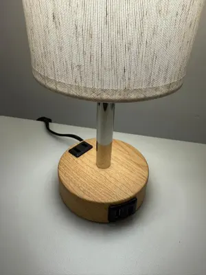 a lamp with a wooden base on a table at Oasis Retreat - Cozy studio in Union Square in New York