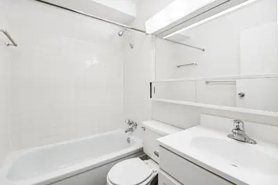 a white bathroom with a sink and a tub and a toilet at PP 1114 Beautiful Professional 1br Apt, Pool in Harrisburg