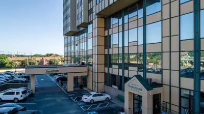a building with cars parked in a parking lot at PP 1114 Beautiful Professional 1br Apt, Pool in Harrisburg
