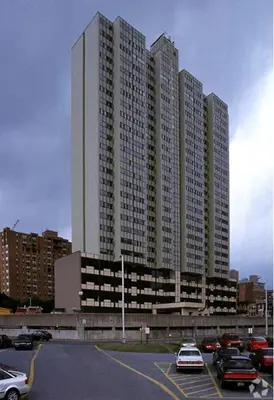 a parking lot with cars parked in front of tall buildings at PP 1114 Beautiful Professional 1br Apt, Pool in Harrisburg