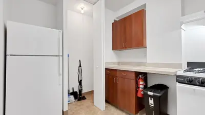 a kitchen with a white refrigerator and wooden cabinets at PP 1203 Corporate 1br, Pool, Free Parking, Gym in Harrisburg
