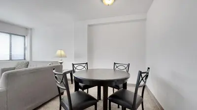 a living room with a table and chairs and a couch at PP 1203 Corporate 1br, Pool, Free Parking, Gym in Harrisburg