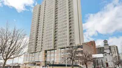a large tall building with trees in front of it at PP 1203 Corporate 1br, Pool, Free Parking, Gym in Harrisburg