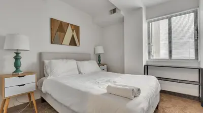 a white bedroom with a white bed and a window at PP 1801 Modern Corporate 2br, pool, Gym in Harrisburg