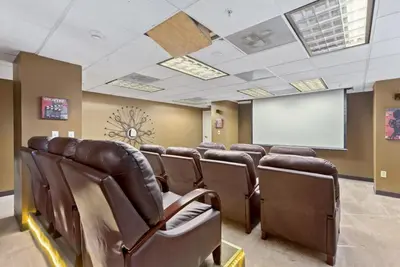 a conference room with leather chairs and a white screen at PP 1801 Modern Corporate 2br, pool, Gym in Harrisburg