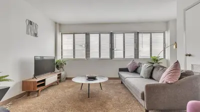 a living room with a couch and a tv at PP 1801 Modern Corporate 2br, pool, Gym in Harrisburg