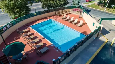 an overhead view of a swimming pool with chairs and an umbrella at PP 514 City Chic in a Modern Studio Haven in Harrisburg